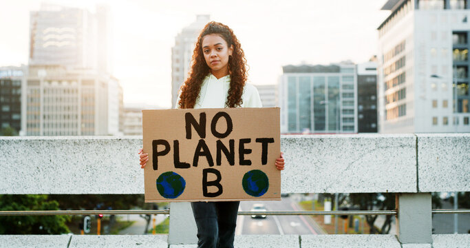 Portrait, woman and protest with poster in city for awareness, climate change and global warming. Female person, billboard sign and stop pollution for planet safety, green movement and society impact
