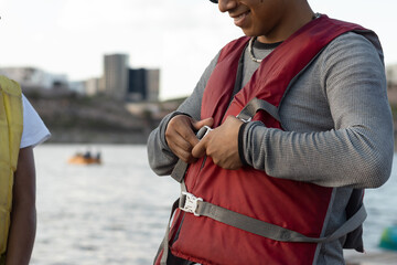 Kayaker fastening his life vest before starting his activity