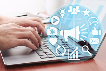 Man hand using laptop with social media business icons for tech connection concept