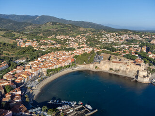 Aerial view of colourful Collioure, narrow streets and yellow, pink, orange houses, summer vacation...
