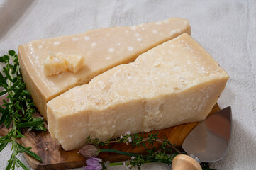 Traditional italian food, 36 months aged in caves Italian parmesan hard cheese from Parmigiano-Reggiano and grana padano from Po river valley, Italy