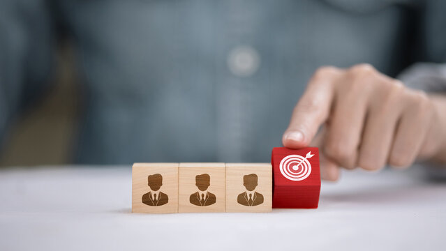Target customer concept with wooden blocks and red goal icon