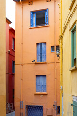 Fototapeta premium View of colourful Collioure, narrow streets and yellow, pink, orange houses, summer vacation destination town with historical buidings and beaches, Pyrenees-Orientales, France