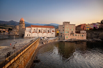 Fototapeta premium Morning view of colourful Collioure, narrow streets and yellow, pink, orange houses, summer vacation destination town with historical buidings and beaches, Pyrenees-Orientales, France