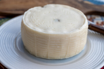 Primo Sale hard cheese made from whole mixed milk, with thin white rind and texture of Sicilian basket fascedde with pickled capers