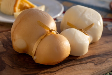Italian semi hard handmade white and smoked scamorza cheese, from cow milk from Apulia or Calabria...