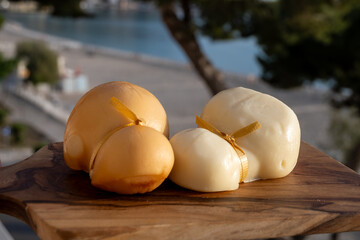 Italian semi hard handmade white and smoked scamorza cheese, from cow milk from Apulia or Calabria...