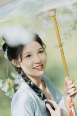 Young Woman with a Parasol in a Blossoming Garden.