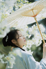 Woman Holding a Parasol Surrounded by Blossoms.