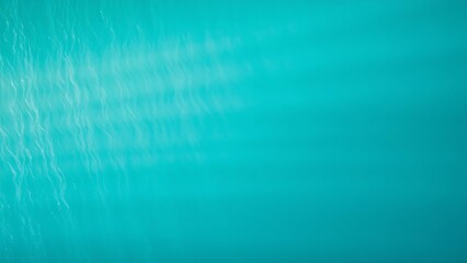 Aerial view of a turquoise coastline with abstract wave patterns and blue tones.