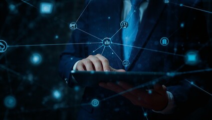 A person in a dark suit uses a tablet computer, interacting with a network of interconnected business icons, representing a modern digital workspace.