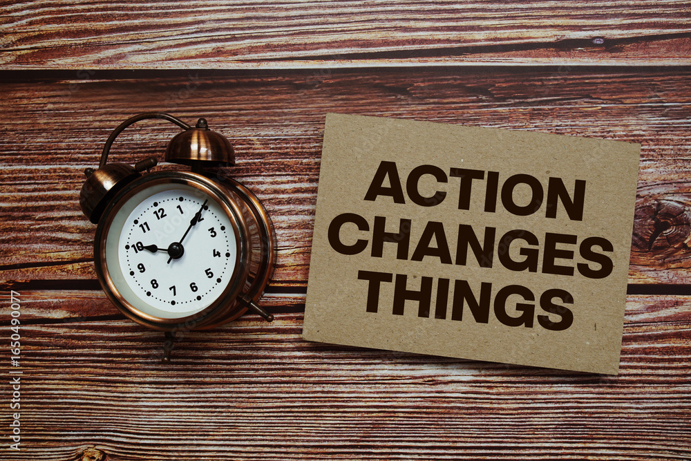 Poster action changes things text with alarm clock on wooden background