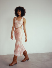 Young woman in fashionable outfit walking with confidence.
