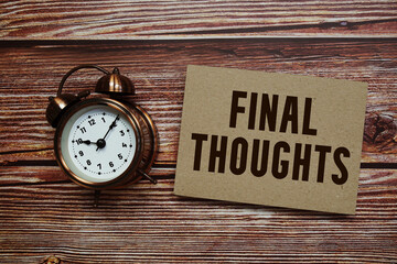 Final Thoughts text with alarm clock on wooden background