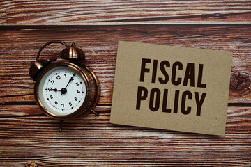 Fiscal Policy text with alarm clock on wooden background