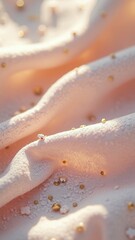Obraz premium Soft pink fabric with gold beads and delicate texture in warm light