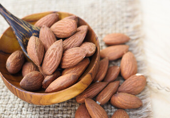 Almonds nuts in wooden bowls with gunny sack