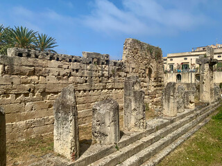 Temple of Apollo in Ortigia, Syracuse - weathered stone columns and ancient ruins bask in the...