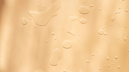 Abstract background of water drops on soft beige orange paper. Water droplets texture. Concept of...