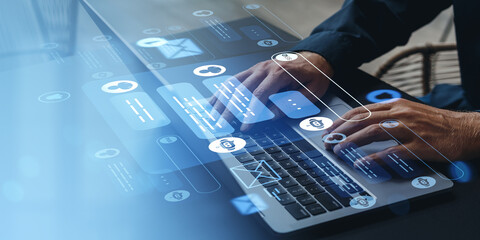 Hands typing on laptop with digital chatbot and message UI overlay concept.