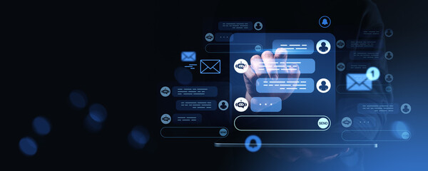 Hand interacting with digital chatbot interface on dark futuristic background.