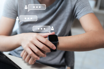 Close-up of a person checking notifications on a smartwatch, floating chat bubbles show social...