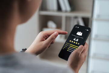 Close-up of a person reading a 4.8-star customer review summary on a smartphone before buying....