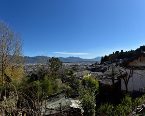 Panoramic View of a Traditional Village Nestled Amongst Mountains Under Clear Skies