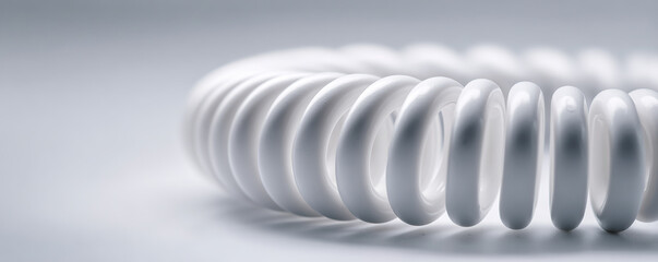 Modern circular object with a smooth white surface displayed on a light background emphasizing minimalistic design