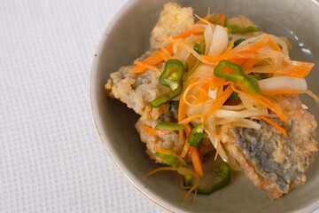 Nanbanzuke , Fried horse mackerel marinated in sweet and spicy vinegar. 
