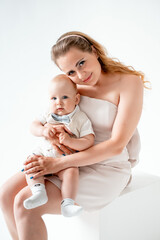 mom with a small child, mom with a newborn baby smiling, hugging, and kissing, happy family on a...
