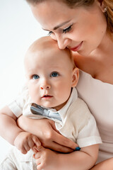 mom with a small child, mom with a newborn baby smiling, hugging, and kissing, happy family on a...