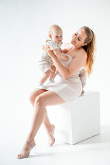 mom with a small child, mom with a newborn baby smiling, hugging, and kissing, happy family on a...