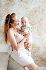 a mother with a small child, a mother with a newborn baby at home, smiling, hugging, and kissing, a...