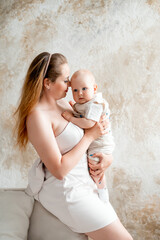 a mother with a small child, a mother with a newborn baby at home, smiling, hugging, and kissing, a...