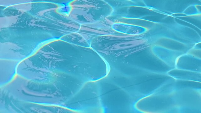 The water in the pool is blue, permeated with glitter and shimmer in the sun. Healthy lifestyle. Recreation for children.