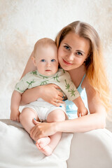 a mother with a small child, a mother with a newborn baby at home, smiling, hugging, and kissing, a...