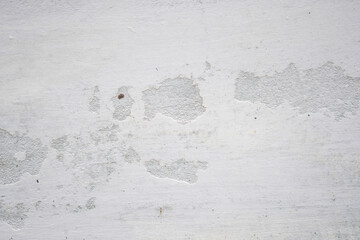 White background, white texture backgrounds cement wall Blank plaster texture in vintage style close-up of an old, cracked, and peeling white wall