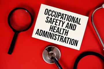 Occupational Safety and Health Administration text written on paper card with stethoscope on red background