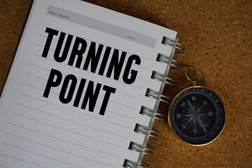 Turning Point text written on notebook paper with compass