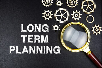 Long Term Planning text message with magnifying glass on black background