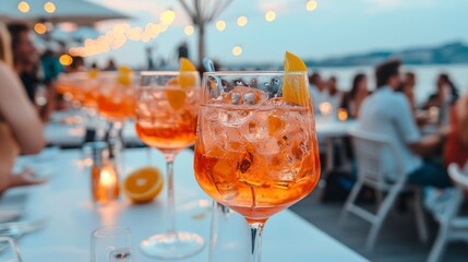 Refreshing cocktails with orange slices served to guests by the beach