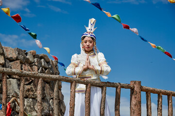 Mongolian girls dressed in luxurious Mongolian costumes on the Mongolian war chariots of the Jinyuan Grand Tent on the grassland