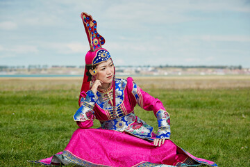 Mongolian girls dressed in luxurious Mongolian costumes on the grassland