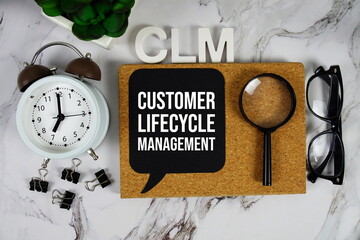 CLM - Customer Lifecycle Management acronym with alarm clock and magnifying glass, business concept...