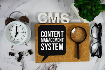 CMS - Content Management System acronym with alarm clock and magnifying glass, business concept...