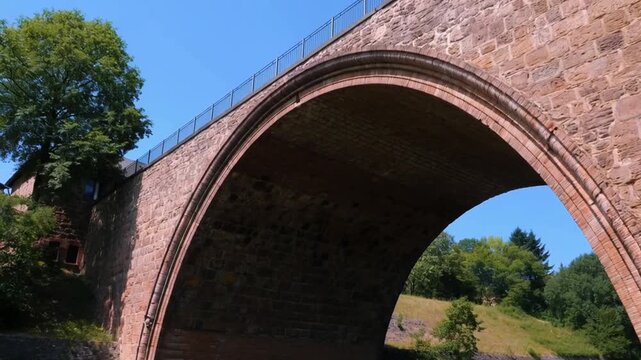 Close-up tilt-up of intricate arch details on a historic bridge
