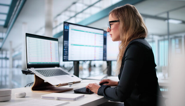 Woman Analyzing Billing Codes On Spreadsheet - Powered by Adobe