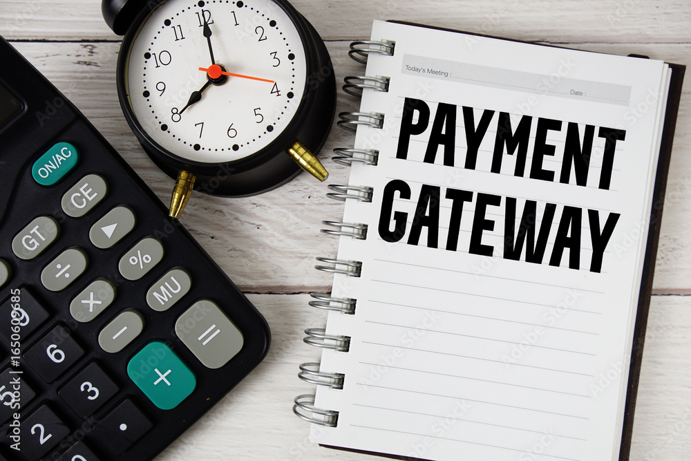 Poster payment gateway text with calculator and alarm clock on wooden background