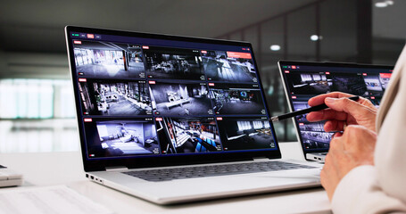 Senior Female Technician Monitoring Security System Camera